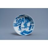 A Chinese blue and white saucer with a kneeling lady with a request, Chenghua mark, Kangxi