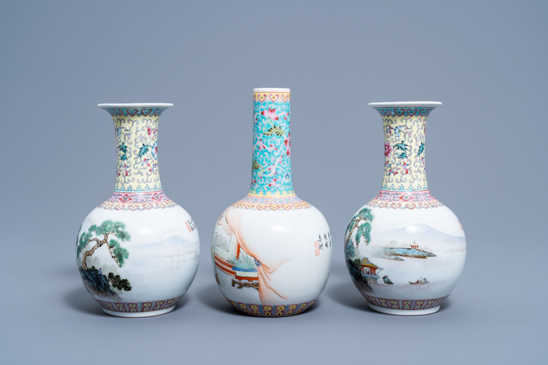 A pair of Chinese bottle shaped famille rose vases with an animated landscape and a vase with figura - Image 2 of 6