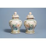 A pair of Chinese Nanking crackle glazed famille rose 'Liu Hai' vases and covers, 19th C.