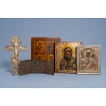 Three Russian icons, one with oklad or riza, a three-piece travel icon and an icon cross, 19th/20th