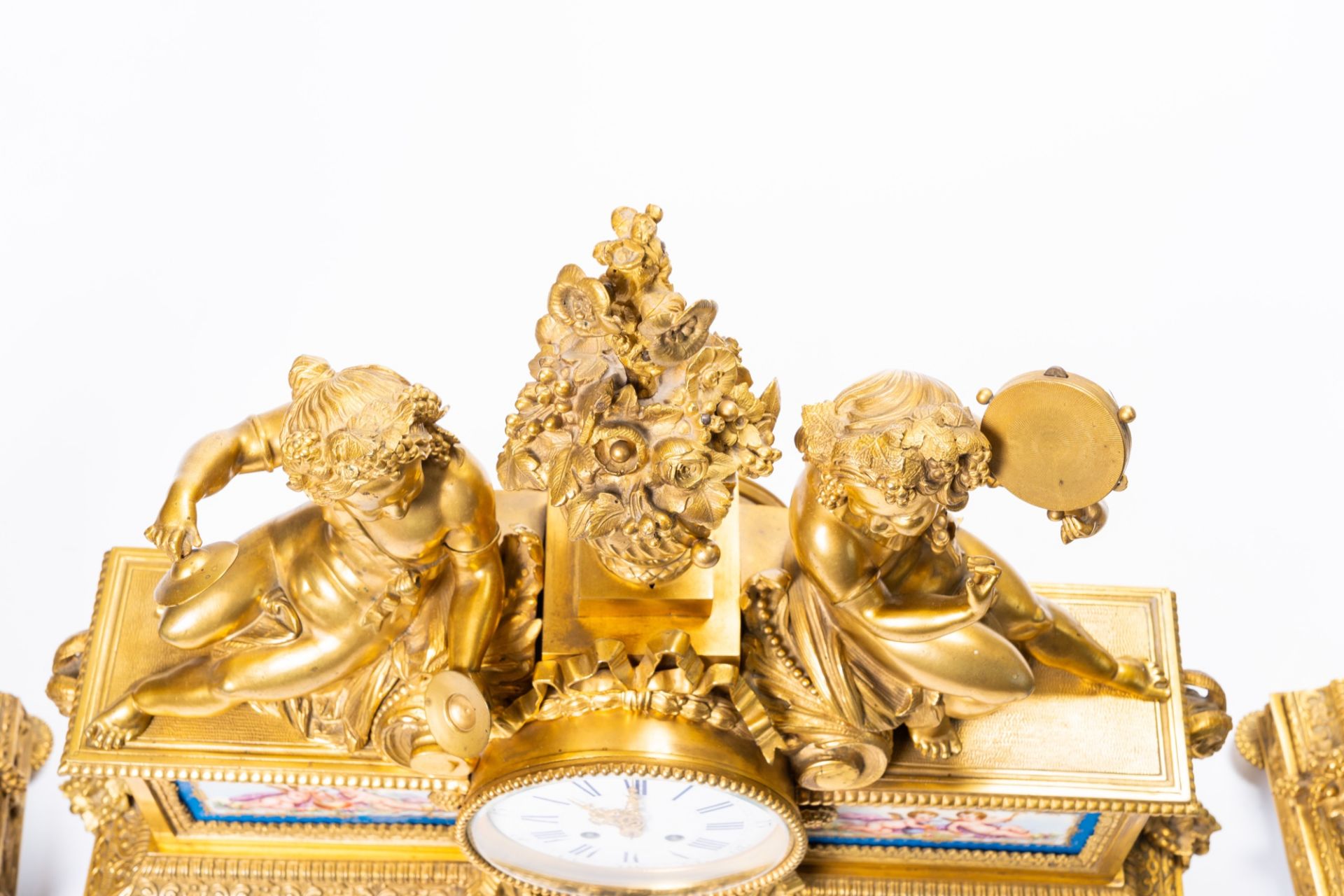 A French gilt bronze three-piece clock garniture with musicians and Svres style plaques, 19th C. - Image 7 of 21