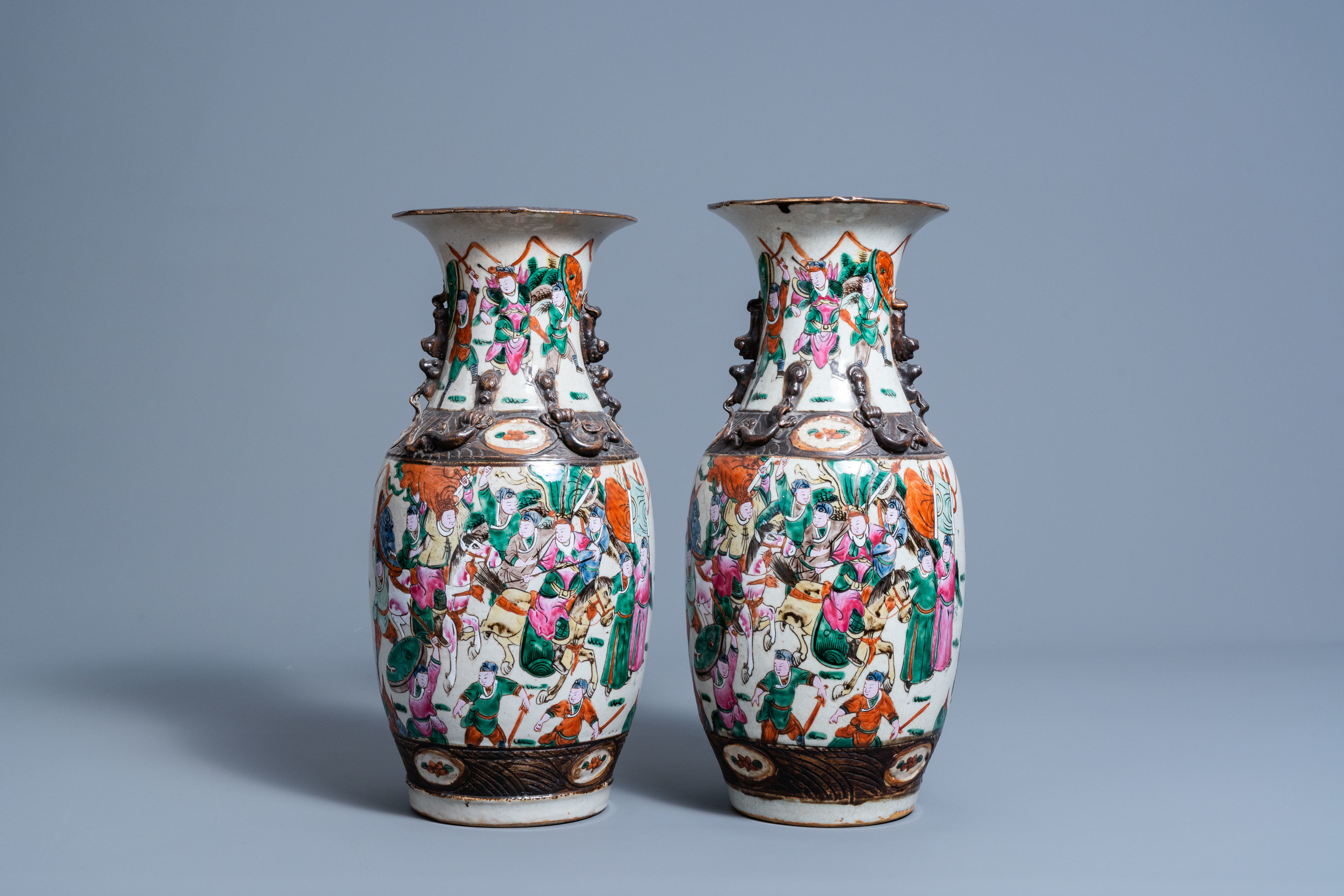 A pair of Chinese Nanking crackle glazed famille rose vases with warrior scenes, 19th C.