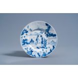 A Chinese blue and white plate with figures in a landscape, Chenghua mark, Kangxi