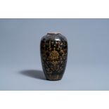 A Chinese monochrome black vase with gilt lotus scrolls, 19th C.