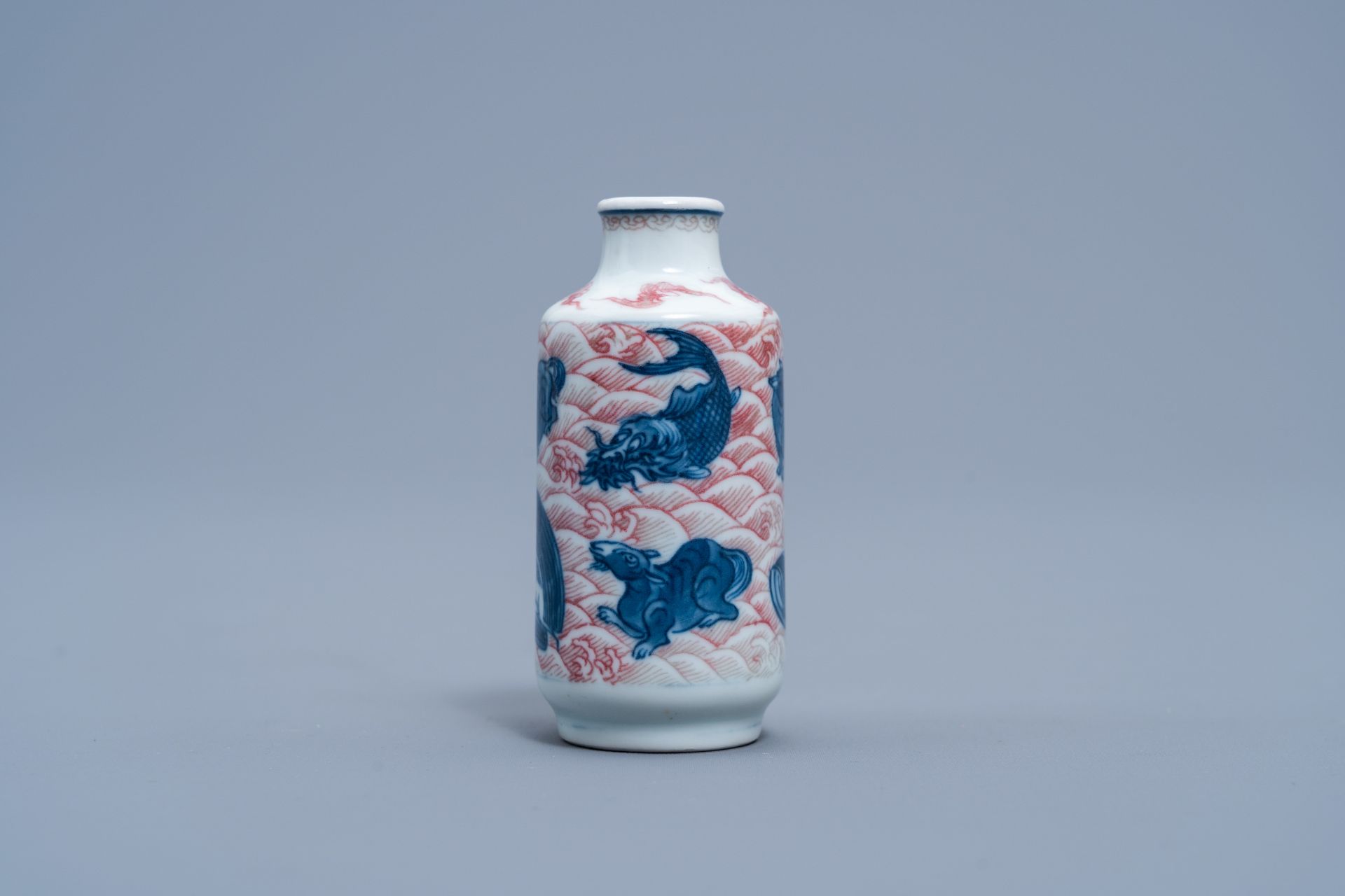 A Chinese blue, white and copper red 'animals' snuff bottle, Yongzheng mark, 20th C.