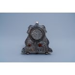 A Polish Art Nouveau style silver mantel clock with floral design set with cabochons, Orno, 20th C.