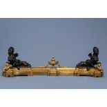 A pair of French Louis XIV gilt and patinated bronze 'sphinxes' chenets and fire fender attributed t