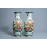 A pair of Chinese Canton famille rose celadon ground vases with figures in a landscape, flowers and