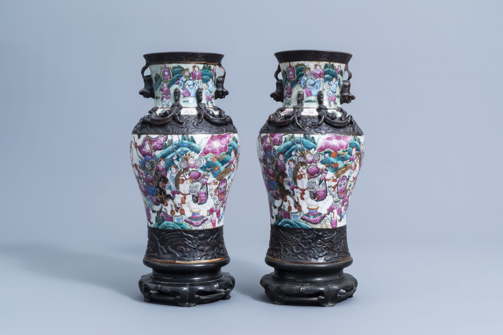A pair of Chinese Nanking crackle glazed famille rose vases with warrior scenes on bronze lotus shap