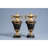 A pair of French gilt and patinated bronze cassolettes with bacchantes relief design on a marble bas