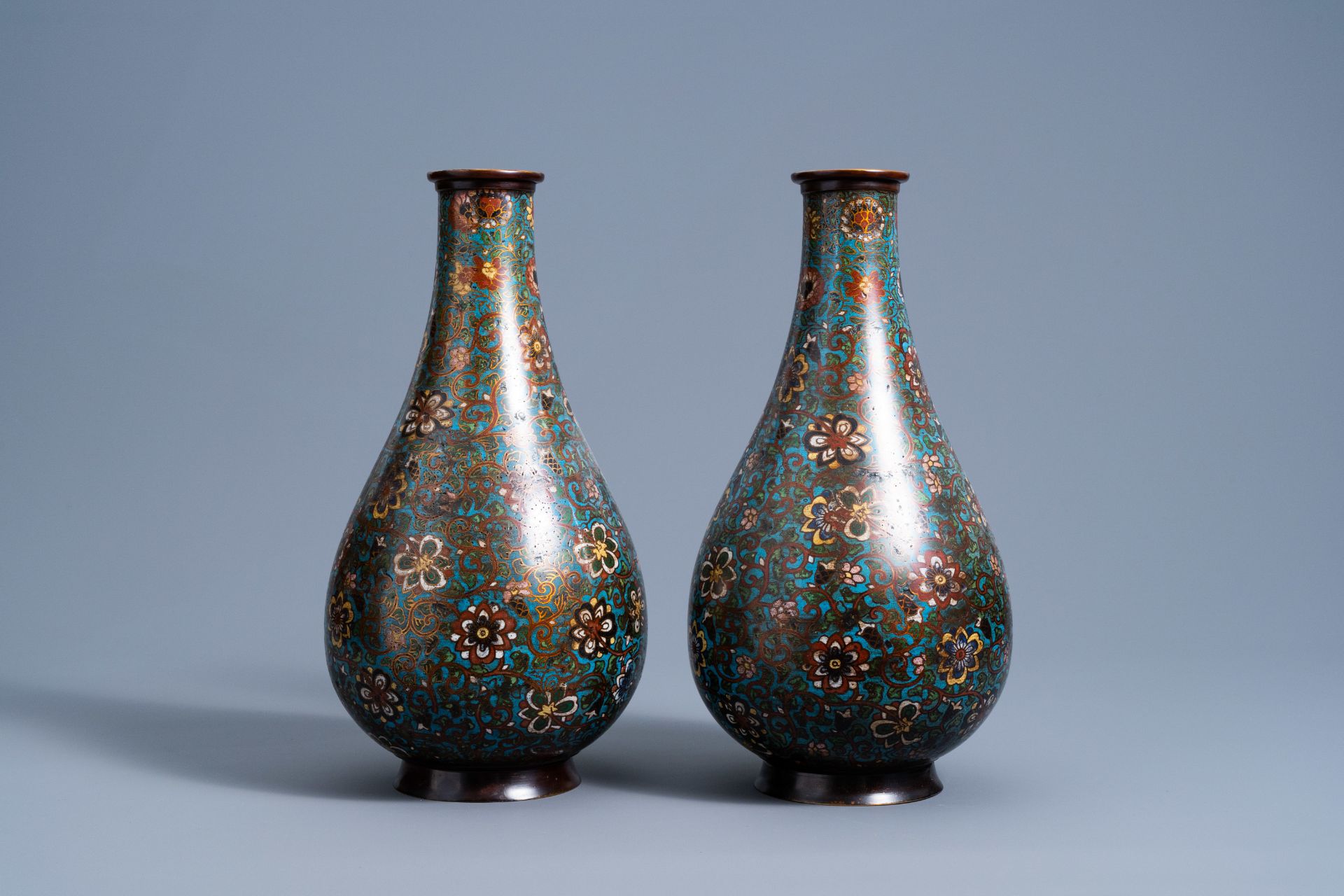 A pair of Chinese bottle shaped cloisonnŽ vases with floral design, 19th/20th C.