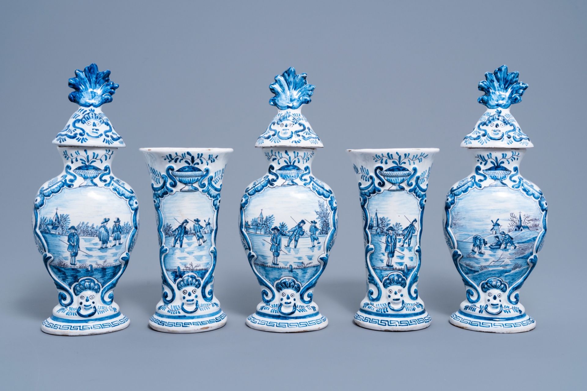 A five-piece Dutch Delft blue and white vase garniture with ice skaters, 19th C.