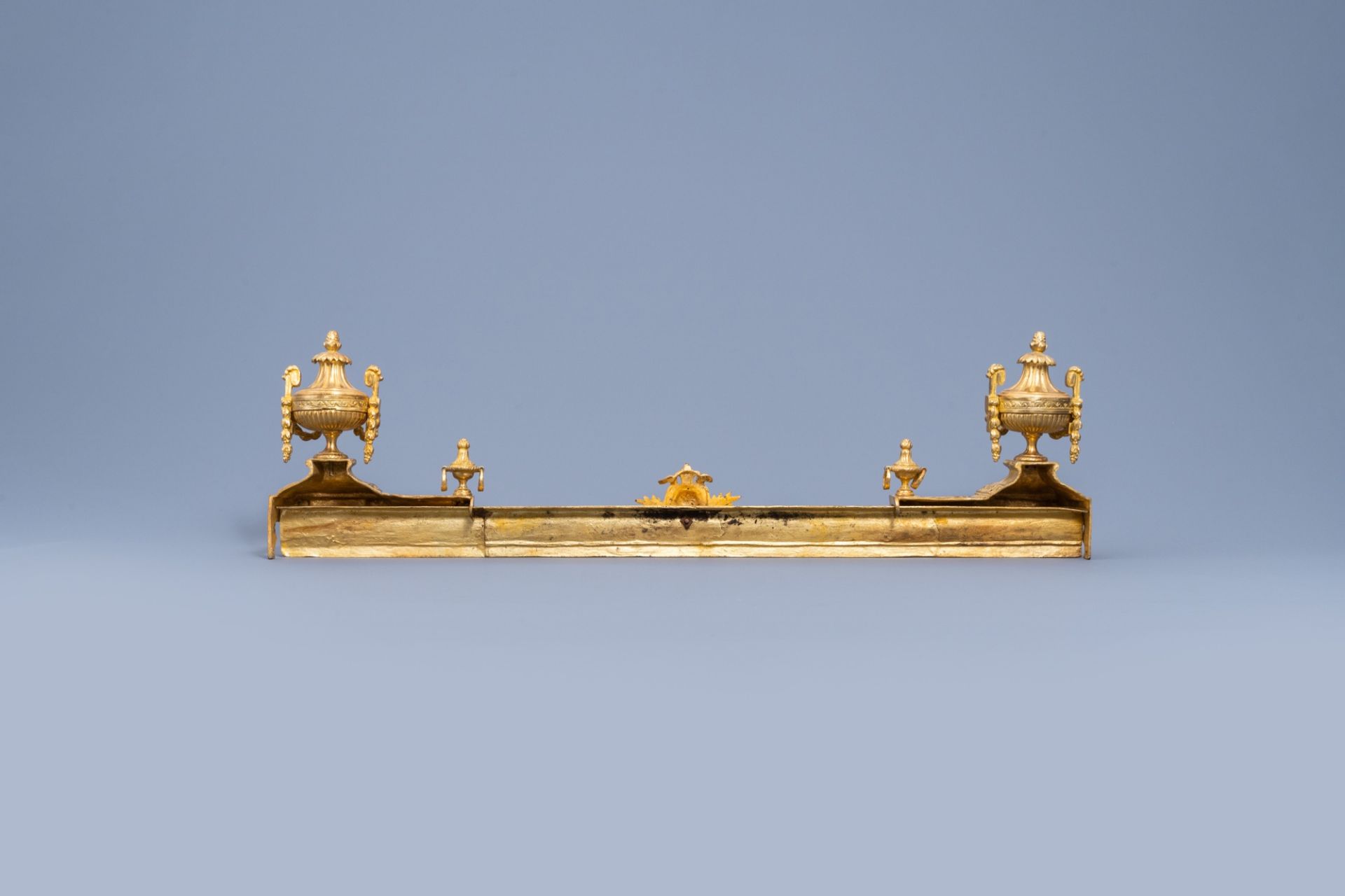 A pair of French Louis XVI style gilt bronze chenets and fire fender, 19th/20th C. - Image 2 of 11