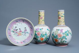 A pair of Chinese famille rose bottle vases with floral design and a charger with ladies in a garden