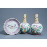 A pair of Chinese famille rose bottle vases with floral design and a charger with ladies in a garden