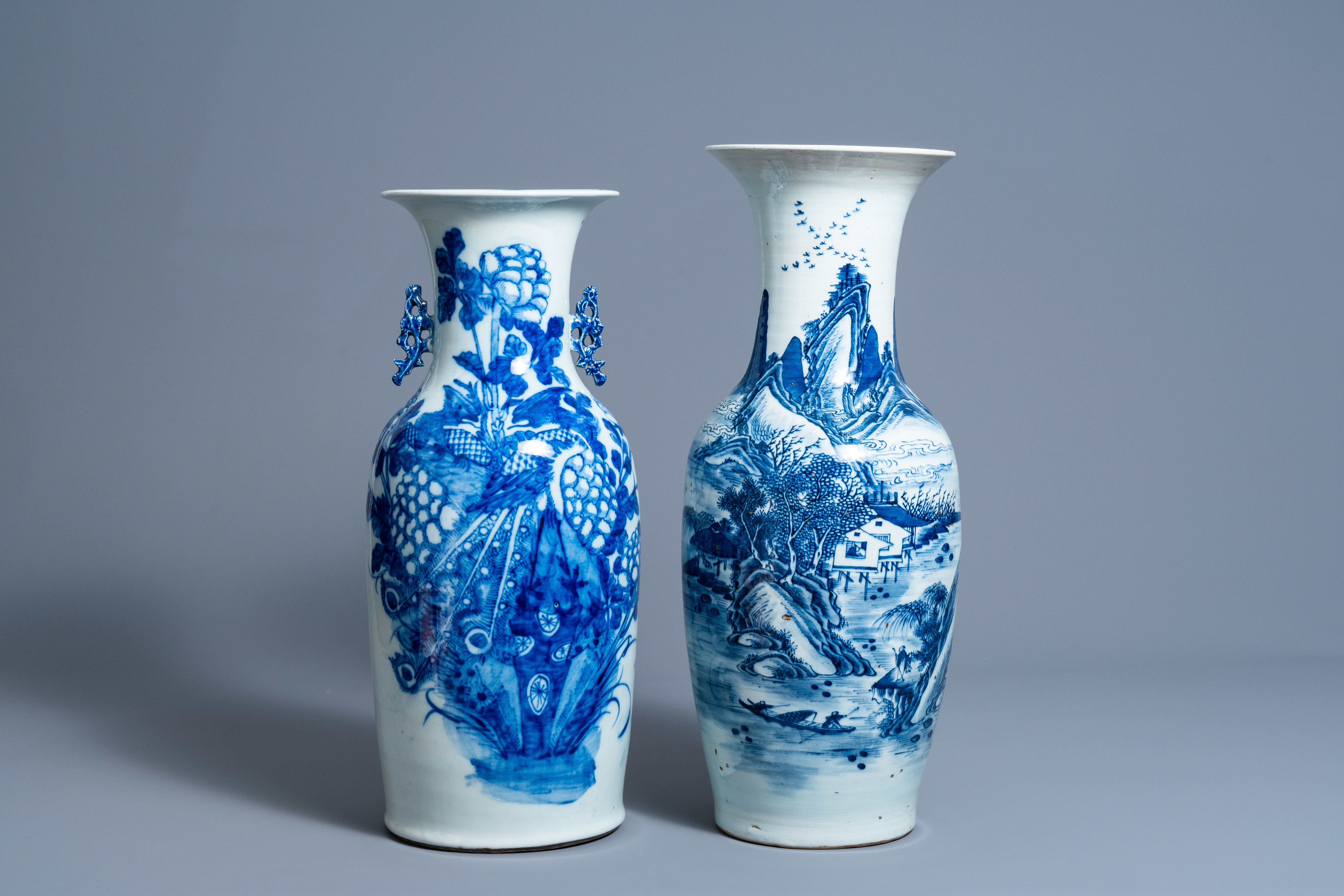 Two Chinese blue and white vases with a phoenix among blossoming branches and an animated landscape,