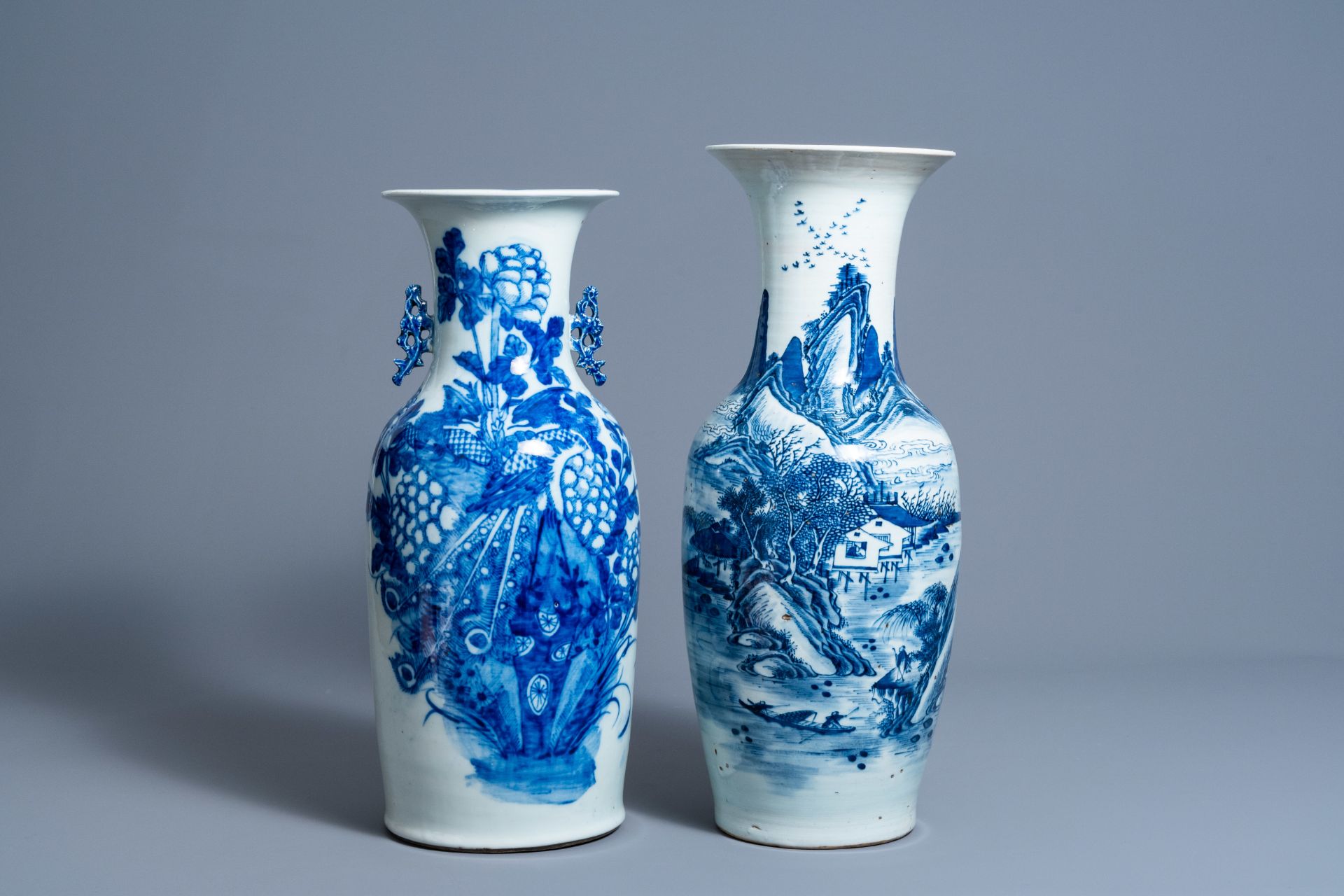 Two Chinese blue and white vases with a phoenix among blossoming branches and an animated landscape,