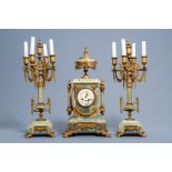 A French Louis XVI style gilt bronze mounted green onyx three-piece clock garniture, first half of t