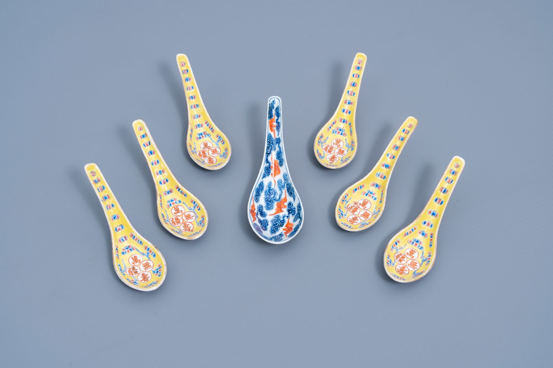 Six Chinese famille rose yellow-ground spoons and a blue, white and iron-red 'bats' spoon, 19th/20th