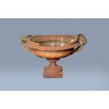 An imposing French or English cast iron garden planter or vase with intertwined snake handles, 19th