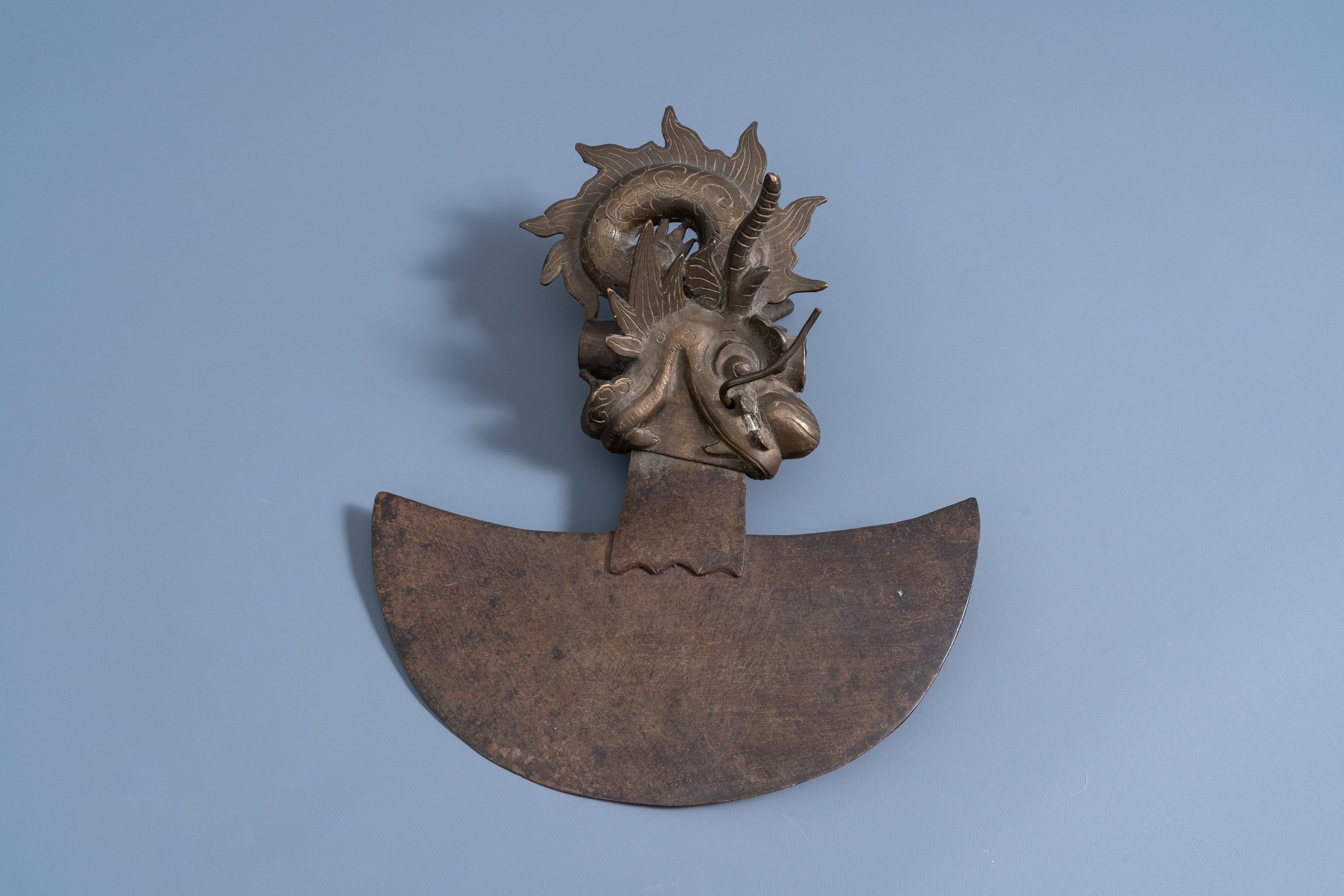 A Tibetan bronze and iron ceremonial axe or kartika with engraved design, 19th/20th C.