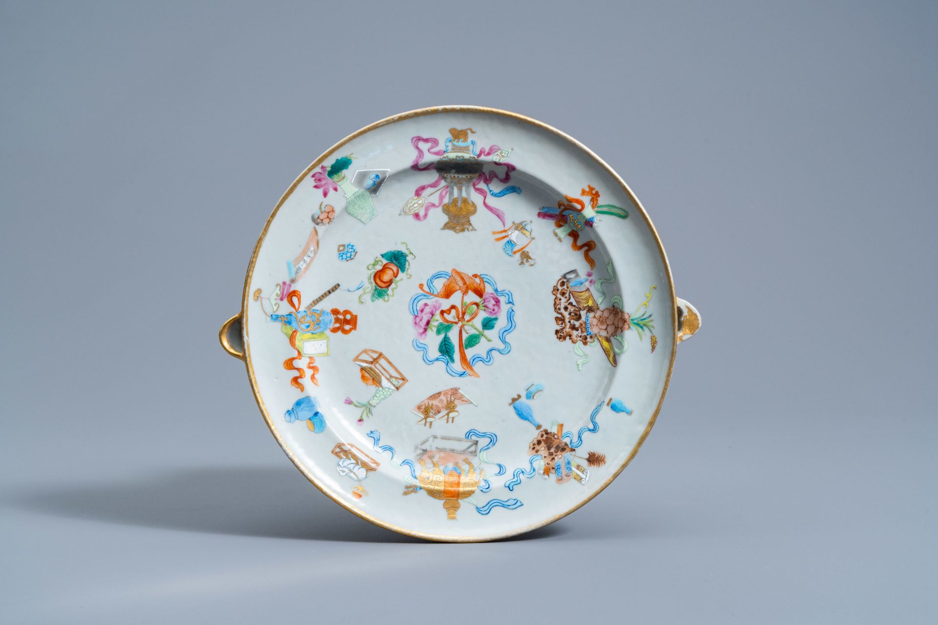 A Chinese Canton famille rose 'antiquities' warming plate, 19th C.