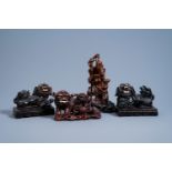 Four Chinese carved wood figures of Shou Lao and Buddhist lions, 19th/20th C.