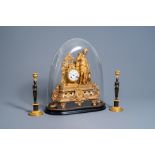 A French gilt zamac 'Diana' mantel clock with accompanying bell jar and a pair of patinated and bron