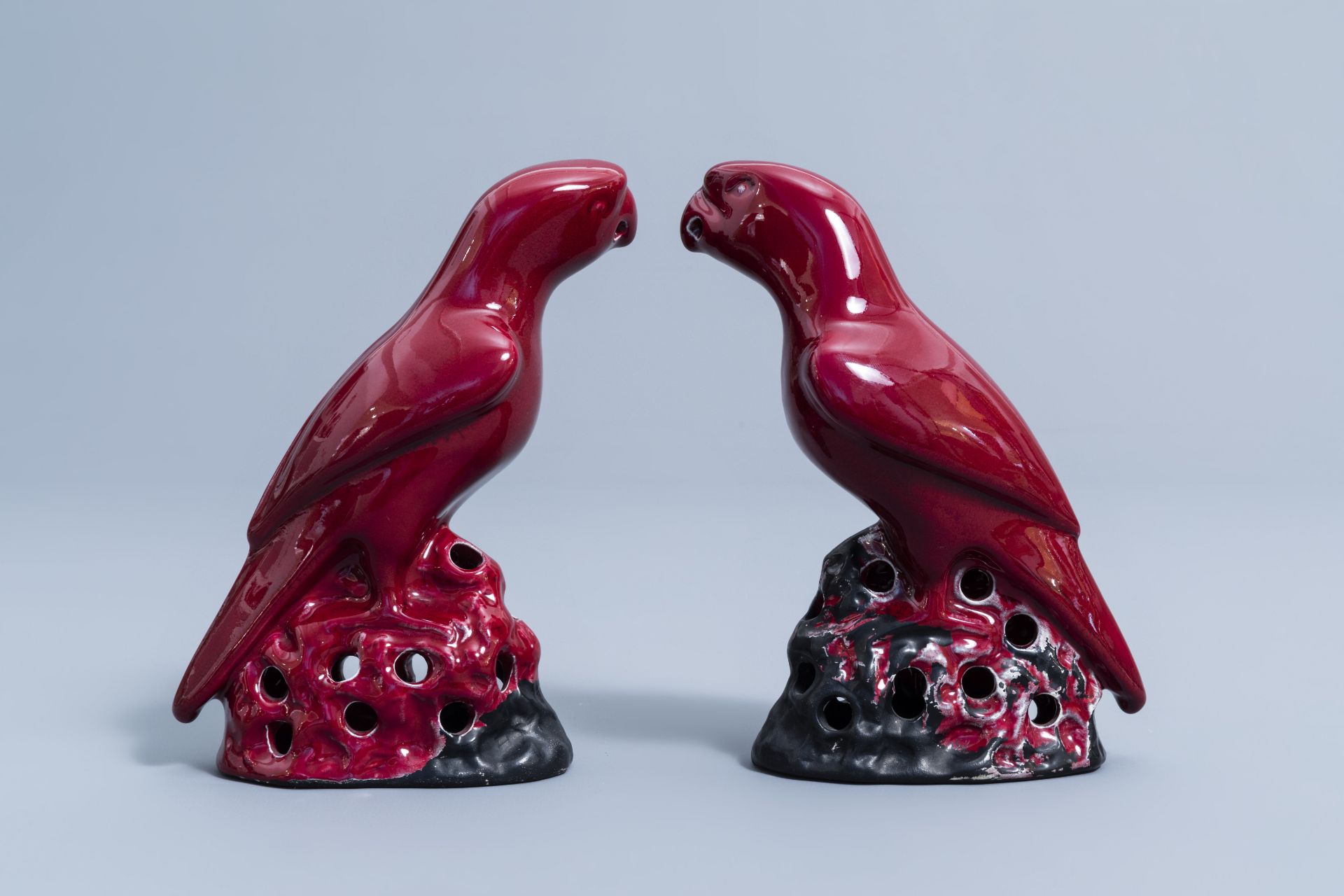 A pair of Chinese red glazed parrots and a monochrome red double gourd vase, 20th C. - Image 4 of 13