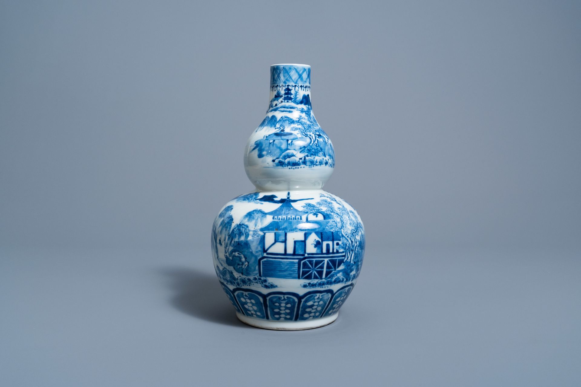 A Chinese blue and white double gourd 'landscape' vase, 19th C.