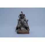A Chinese bronze figure of a seated dignitary, Ming