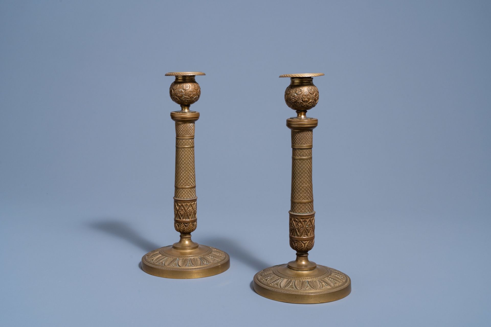 A pair of French bronze candlesticks with floral design, 19th C.