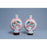 A pair of Chinese famille rose moon flasks with warrior scenes and pheasants among blossoming branch