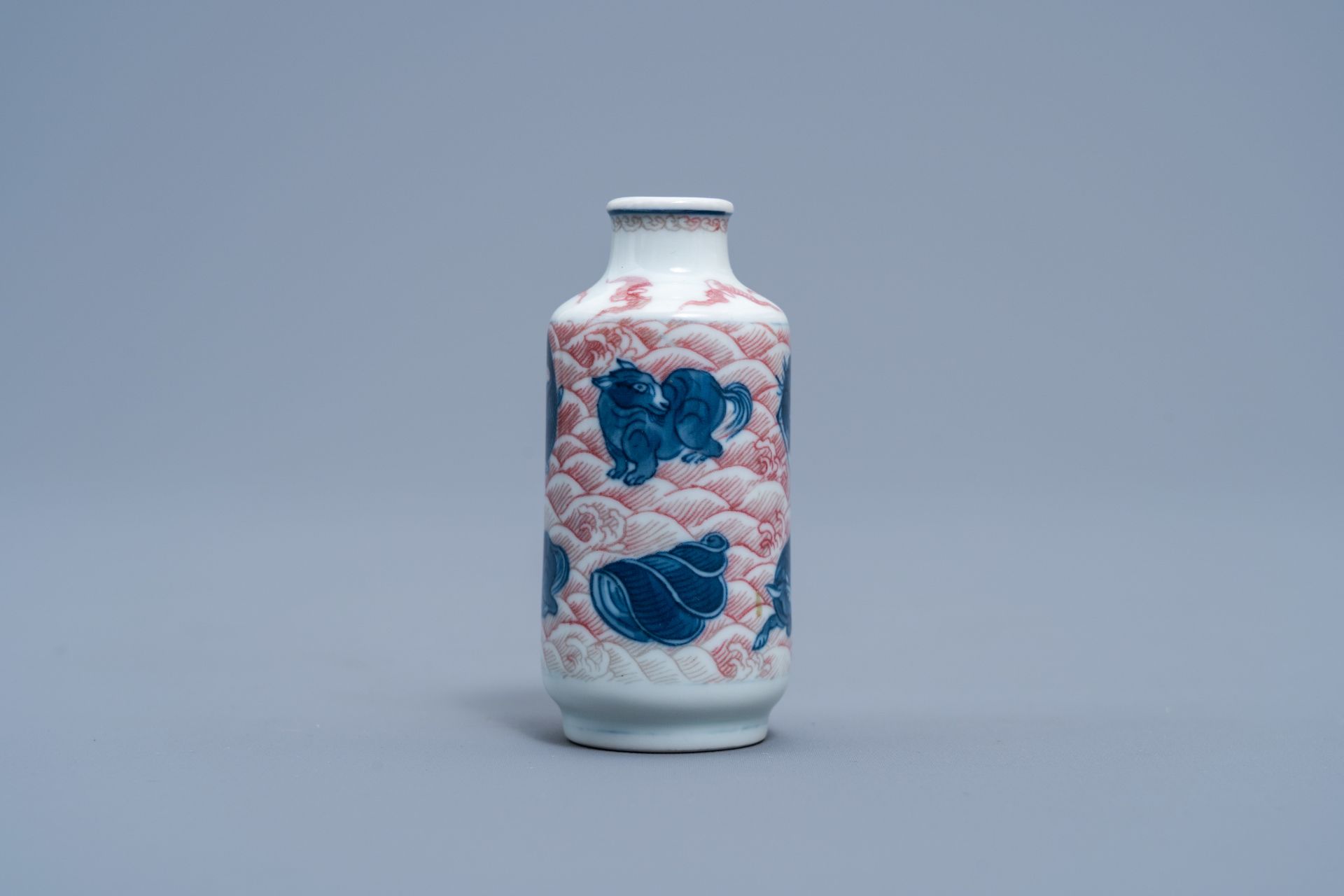 A Chinese blue, white and copper red 'animals' snuff bottle, Yongzheng mark, 20th C. - Image 2 of 6