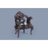 A Japanese carved wood 'dragons and irises' chair, 19th/20th C.