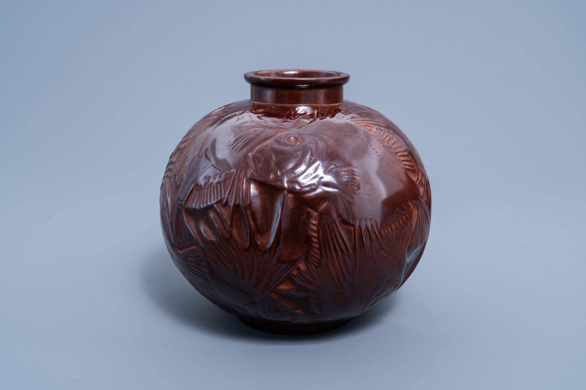 A Japanese brown patinated bronze Art Deco vase with fish relief design, Showa, 20th C.