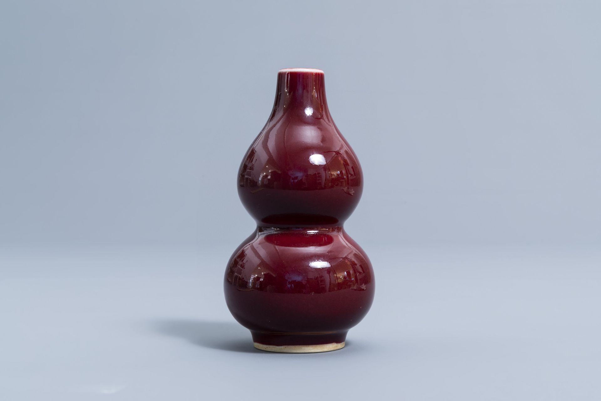 A pair of Chinese red glazed parrots and a monochrome red double gourd vase, 20th C. - Image 11 of 13