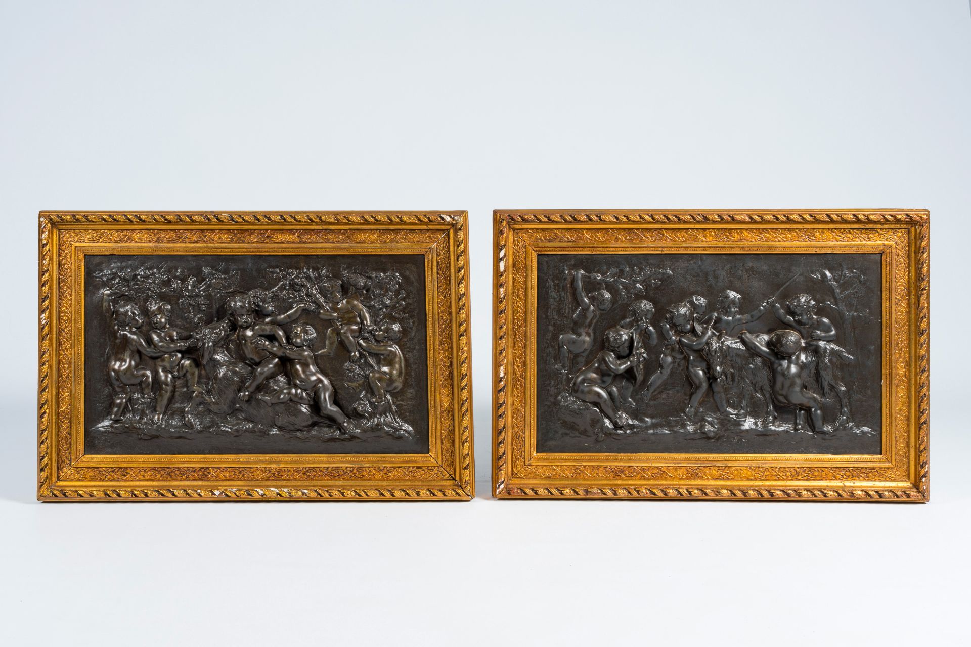 A pair of large French bronze patinated copper plaques with relief design of putti, goats and Bacchu