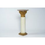 A polychrome and gilt wood pedestal in the form of a column with capital, ca. 1900