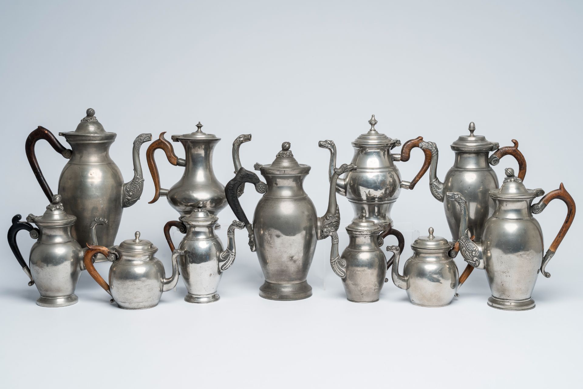 Eleven various pewter Empire 'dragon spout' jugs with wood handle, a.o. Brussels and Antwerp, 19th C