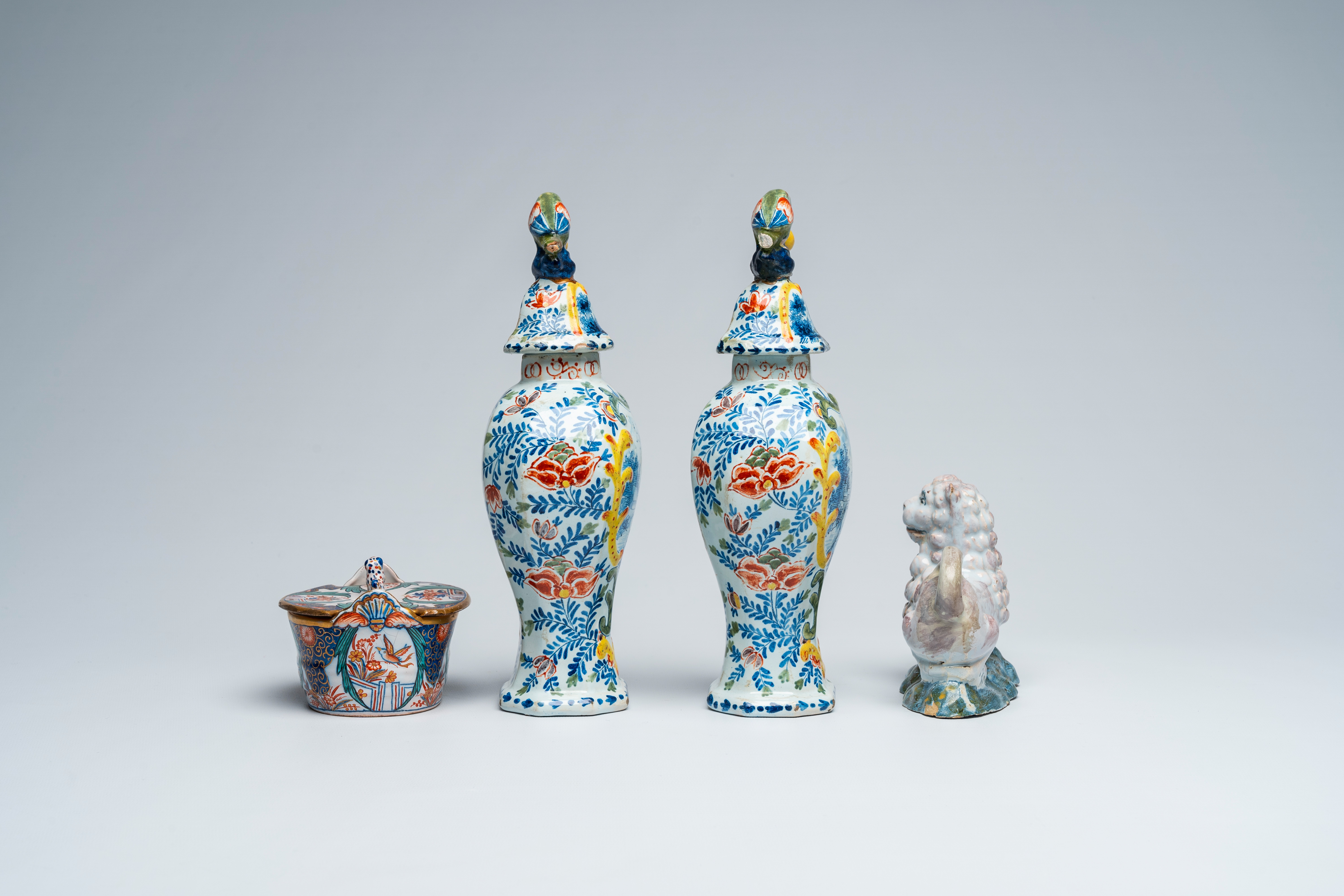 A pair of polychrome Delft vases and covers, a butter tub and a reclining lion, 18th and 19th C. - Image 5 of 7
