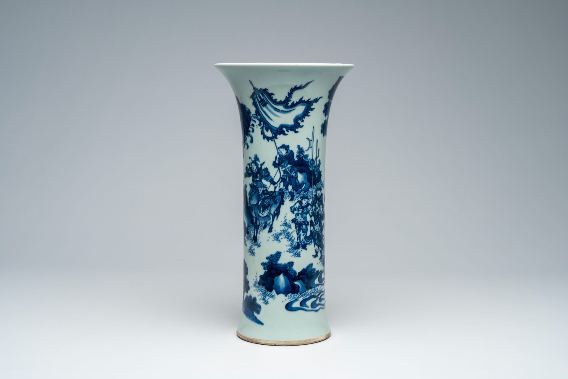 A Chinese blue and white Transitional style beaker vase with warriors in a landscape, 20th C.