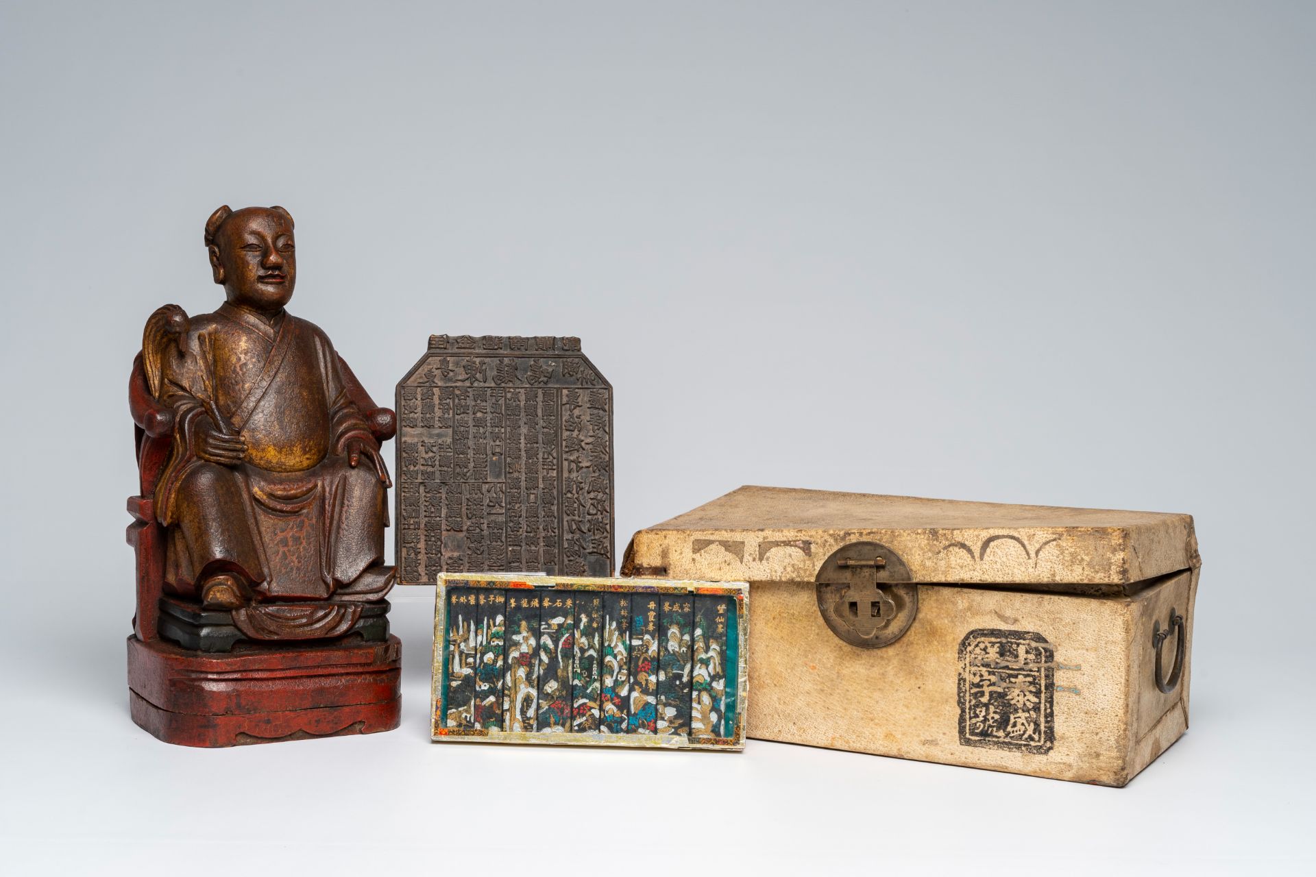 A Chinese polychrome wood sculpture, a collection of printing stamps and a travel case, 19th/20th C.