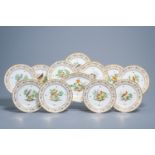 A set of eleven French plates and one oval charger with gilt and polychrome exotic birds design, fir