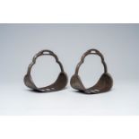 A pair of Tibetan or Mongolian silver inlaid iron stirrups, 18th/19th C.