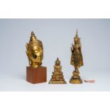 Two Thai gilt bronze figures of a standing and a seated Buddha and a Buddha head, Rattanakosin and l