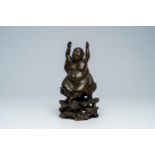 A Vietnamese bronze figure of Buddha seated on a rock, 19th C.