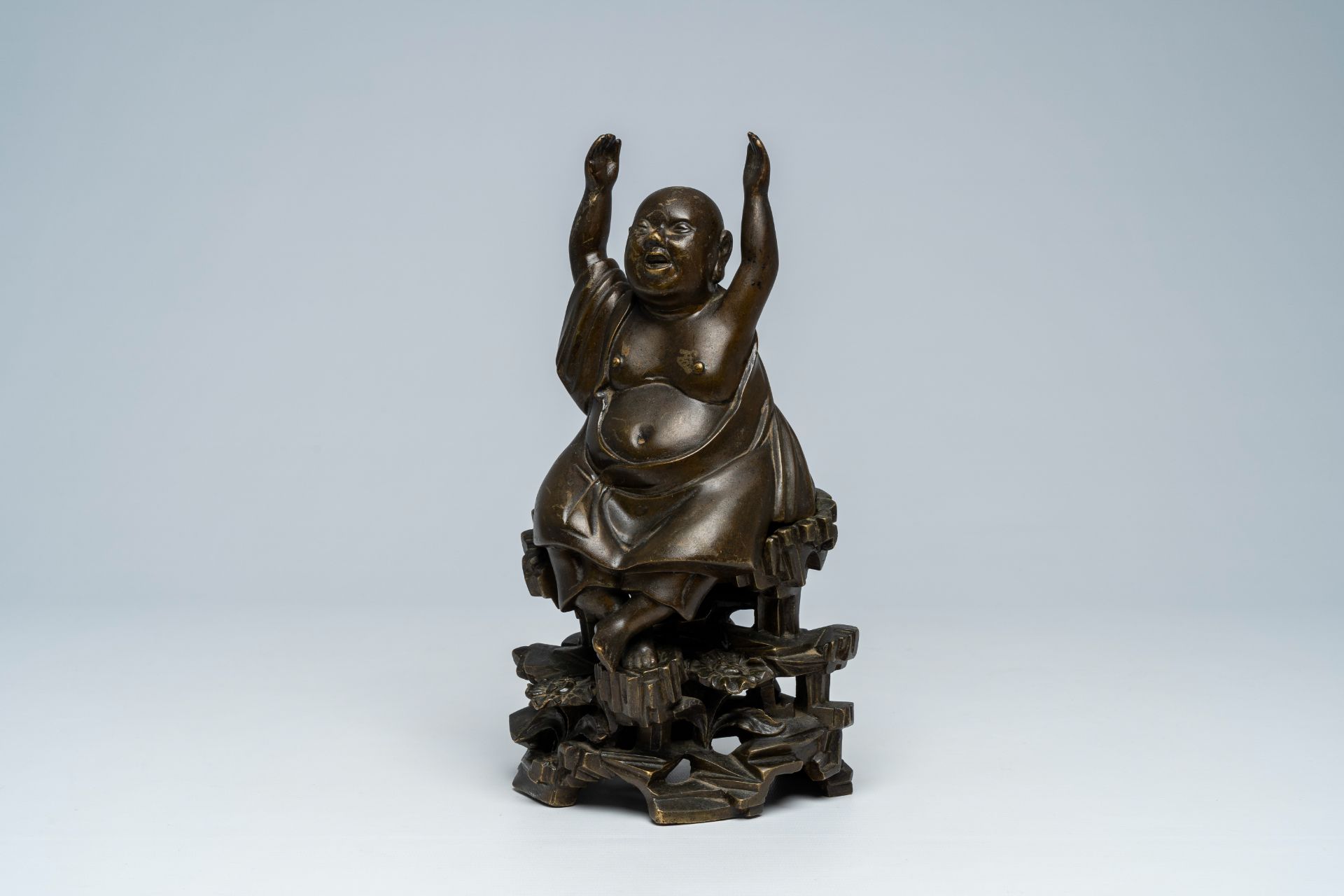 A Vietnamese bronze figure of Buddha seated on a rock, 19th C.