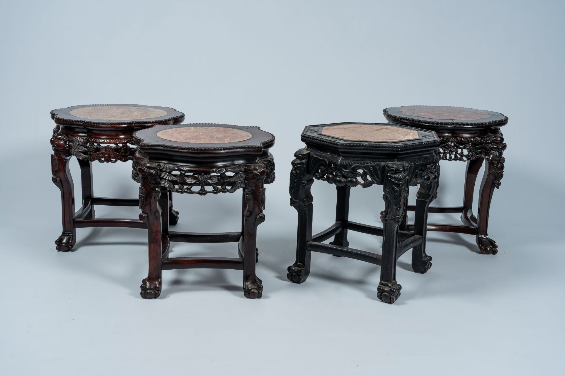 Four Chinese open worked carved wood stands with marble top, 19th/20th C.