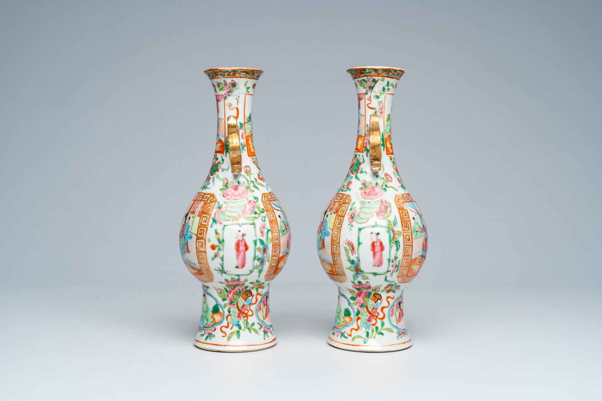 A pair of Chinese Canton famille rose vases and with palace scenes and floral design, 19th C. - Image 4 of 6